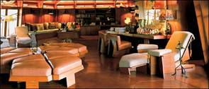 The living room of the main house establishes the motifs that run through Auldbrass: red cypress planks, canted walls and hexagons. 